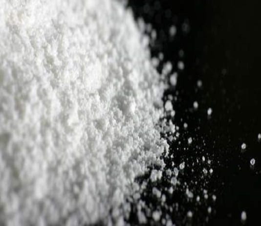 White powder A heap of white powder on black floor.
